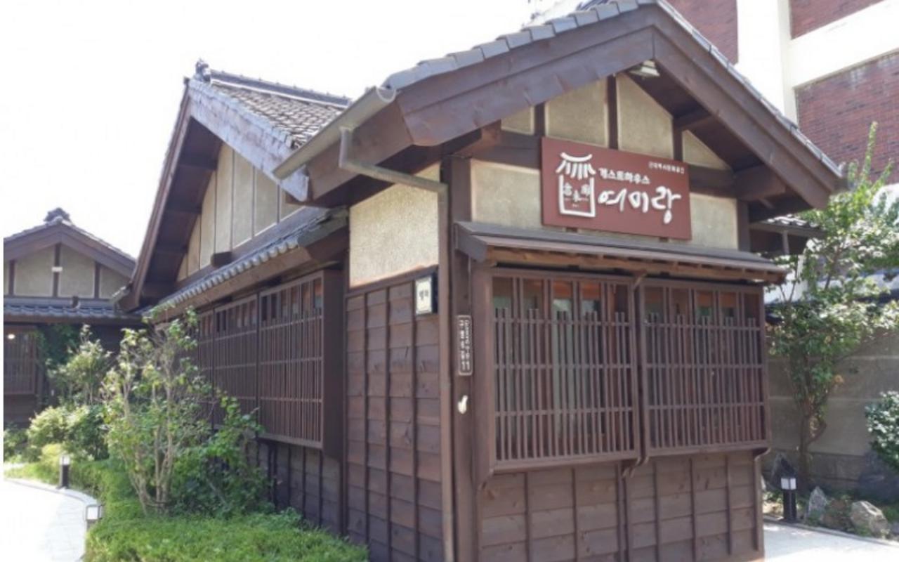 격자무늬 창문과 기와지붕이 있는 별채 목조 건물 전경입니다.
